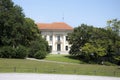 Secluded traditional white mansion with red rood in sunny day, h Royalty Free Stock Photo