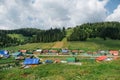 Secluded village on a side of a hill with a lush connifer forest Royalty Free Stock Photo