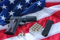 The second amendment and gun control in the US, concept. A handgun, a magazine, bullets, and the american constitution on the USA Royalty Free Stock Photo