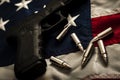 The second amendment and the right to bare arms concept with a grungy image of a gun and bullets on american flag. In the United Royalty Free Stock Photo