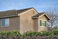 Second floor exterior of a house with light brown siding and bricks roof at Southern California