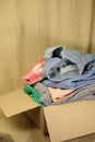 second-hand clothes are stacked on top of each other blue jeans knitted sweater and colored green and pink pants Royalty Free Stock Photo