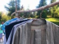 Second hand garage sale outdoors. Rack of old fashioned women& x27;s clothes for reselling,recycling,donation,reusing or