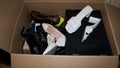 second-hand shoes for a consignment store are collected in a cardboard box