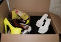 second-hand shoes for a consignment store are collected in a cardboard box