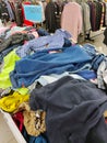 In the second-hand store, there are baskets with a variety of clothes in bulk for different tastes Royalty Free Stock Photo