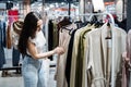 Second hand. Sustainable fashion. Young Latina woman buying used sustainable clothes from second hand charity shop Royalty Free Stock Photo