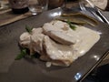 Chopped chicken resting on a mustard and rosemary cream