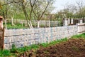 Second life of a plastic bottles, as a fence at the cottage Royalty Free Stock Photo