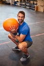 This is second nature to me. High angle portrait of a handsome young man working out with a medicine ball in the gym. Royalty Free Stock Photo