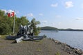 A decommissioned artillery piece pointing towards the hills surrounding Whycocomagh bay on the Bras d`Or lakes in Cape Breton