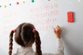 Schoolgirl counting mathematical equations on the board Royalty Free Stock Photo