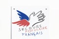 Secours Populaire Francais logo on a wall