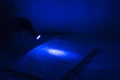 Secret documents reading. Ultra violet light abstract photo. Royalty Free Stock Photo