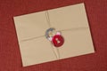 A secret envelope, a parcel bound with a rope, with symbolic lock. Open the lock.