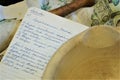 Handwritten salad recipe with dishtowel and antique mortar pestle