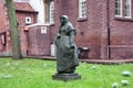 Secret garden of the beghine of amsterdam. statue in the middle of the green in the reserved and silent neighborhood inhabited by