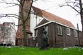 Secret garden of the beghine of amsterdam. statue in the middle of the green in the reserved and silent neighborhood inhabited by