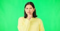 Secret, green screen and face of serious woman in studio, finger and lips on background for privacy. Portrait, angry