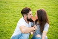 Secret kiss. Man bearded hipster and pretty woman in love. Summer vacation. Happy together. Couple in love cheerful