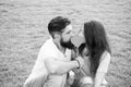 Secret kiss. Man bearded hipster and pretty woman in love. Summer vacation. Happy together. Couple in love cheerful