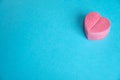 Secret, mystery, gift in heart shaped pink box on flat beautiful blue background. Concept of gift, joy, happiness