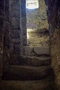 Secret passage with ascending steps in the stone wall of an ancient dilapidated synagogue. The texture of the old dilapidated