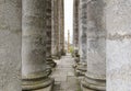 Corridor of ancient columns. A secret passage, two long rows of ancient stone columns everywhere, a tunnel. Rows of columns. Archi Royalty Free Stock Photo