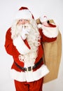 Secret, quiet and santa with christmas gift sack for silent holiday present giving in red suit. Silence of santa claus