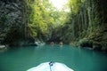 A secret road leads to a deep dark cave, an azure mountain river glistens in the sun, long creepers and tree branches