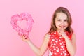 Secret and silence Girl holding rosy heart on pink background.