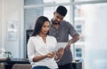 The secret to getting ahead is getting started. two businesspeople working together on a digital tablet in an office. Royalty Free Stock Photo