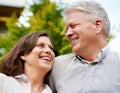 The secret to their happy marriage is love and laughter. an affectionate senior couple standing face to face. Royalty Free Stock Photo