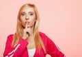 Secret woman. Fitness girl showing hand silence sign Royalty Free Stock Photo