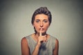 Secret woman. Young female showing hand silence sign, asking to keep it quiet Royalty Free Stock Photo