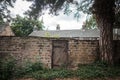 Secret wooden gate entrance to garden of old stone cottage closed.