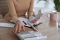 Secretary dialing number on telephone at wooden table in office, closeup Royalty Free Stock Photo