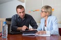 Secretary helping boss with tablet in office Royalty Free Stock Photo