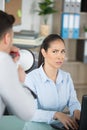 secretary looking disdainfully at colleague talking through megaphone Royalty Free Stock Photo