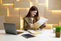 The secretary looks through the mail with documents, the woman manager checks the accounts