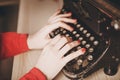 Secretary at old typewriter with telephone. Young woman using ty Royalty Free Stock Photo