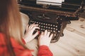 Secretary at old typewriter with telephone. Young woman using ty Royalty Free Stock Photo