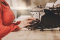 Secretary at old typewriter with telephone. Young woman using ty Royalty Free Stock Photo