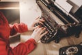 Secretary at old typewriter with telephone. Young woman using ty Royalty Free Stock Photo