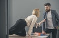 Secretary pulls jacket of boss in office, seduction and flirting concept Royalty Free Stock Photo