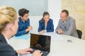 Secretary taking minutes meeting on computer