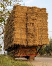 A section of an agricultural vehicle loaded with bales of straw