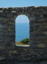 Section of ancient wall around the Doria Castle in Portovenere with an arched window hole Royalty Free Stock Photo