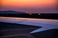 Section of business jet wing set against sun rise Royalty Free Stock Photo
