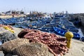 A section of the busy fishing harbour at Essaouira in Morocco showing fishing nets, small boats and trawlers. Royalty Free Stock Photo